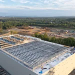 Aerial view of a large hyperscale data center campus under construction at dusk