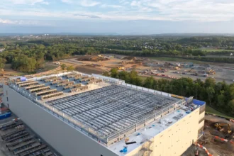 Aerial view of a large hyperscale data center campus under construction at dusk