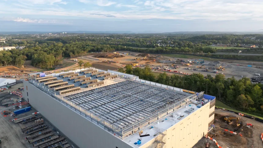 Aerial view of a large hyperscale data center campus under construction at dusk