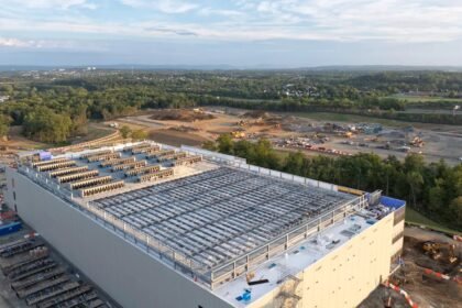 Aerial view of a large hyperscale data center campus under construction at dusk