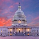 United States Capitol building viewed across a wide landscape at dusk, evoking the federal-state fight over AI regulation